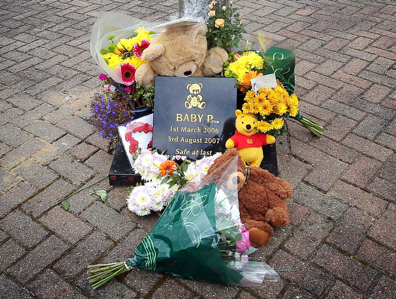 the Grand Mother of Baby P attends his resting place at Islington & St. Pancras Cemetery in north London on the 5th anniversary of his death.