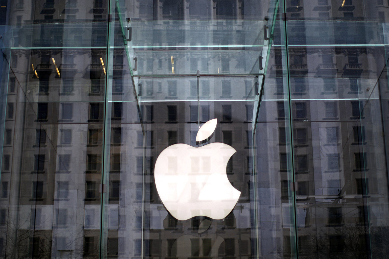 The Apple logo hangs inside the glass entrance to the Apple Store on 5th Avenue in New York City, in this April 4, 2013, file photo. Apple has operated almost tax-free in Ireland since 1980, welcomed by a government keen to bring jobs to what w