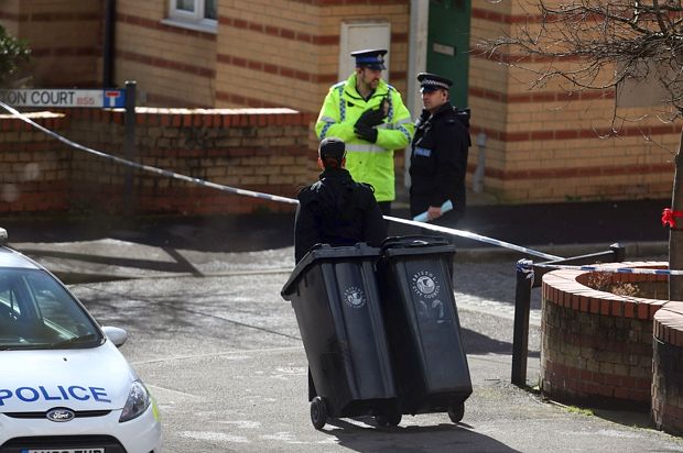 Detectives searching for clues remove wheelie bins