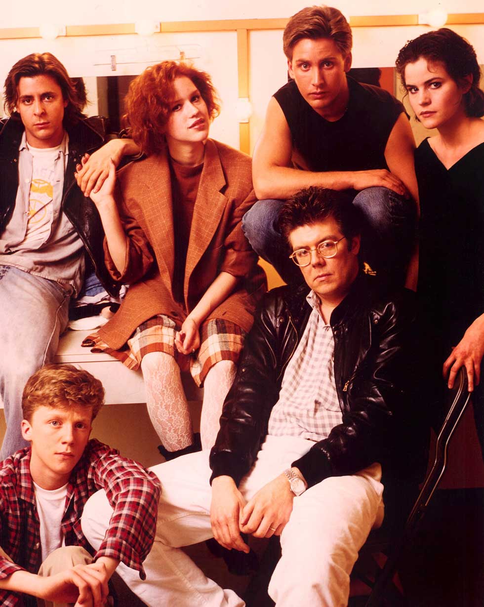 Judd Nelson, Anthony Michael Hall, Molly Ringwald, Emilio Estevez, director John Hughes, Ally Sheedy on the set of BREAKFAST CLUB, 1985