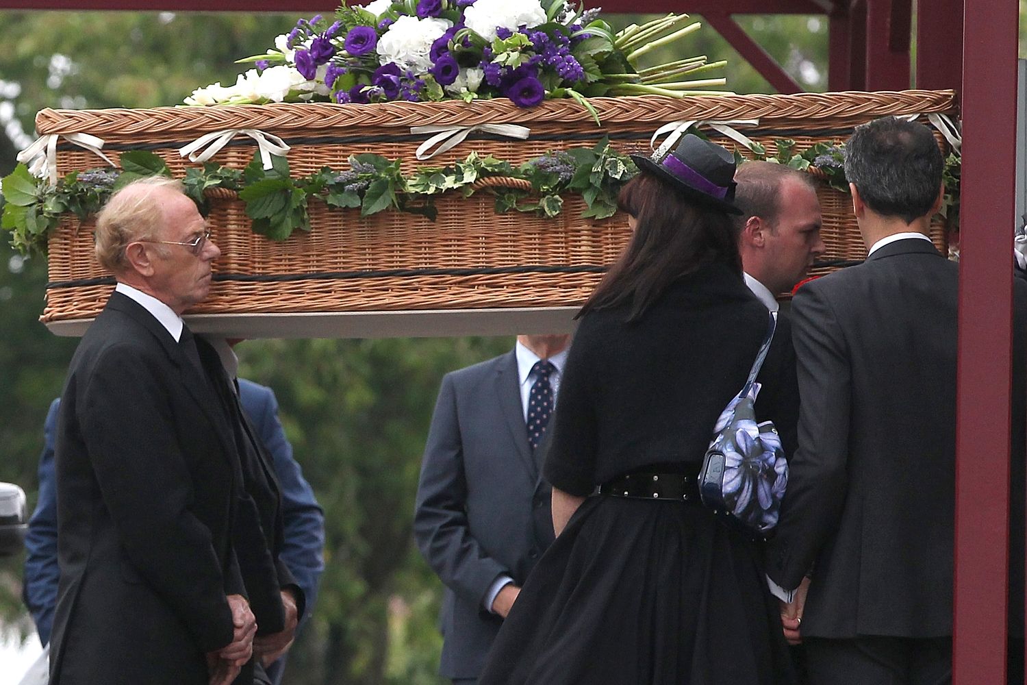 Coffin being carried by family