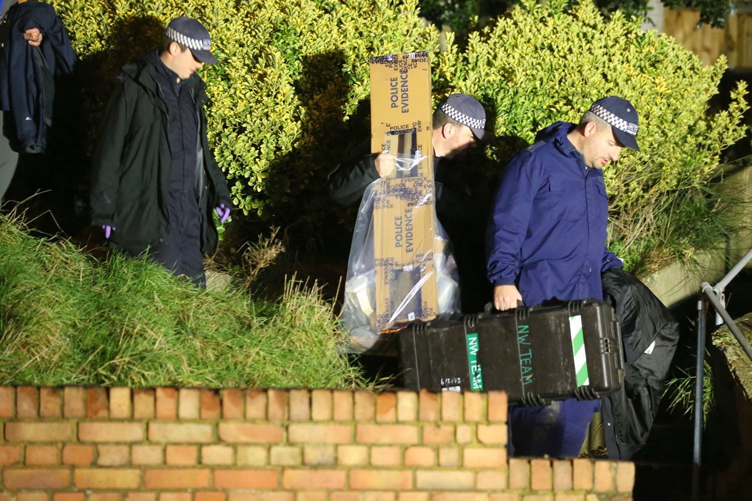 Evidence ... forensic teams take items from garden crime scene