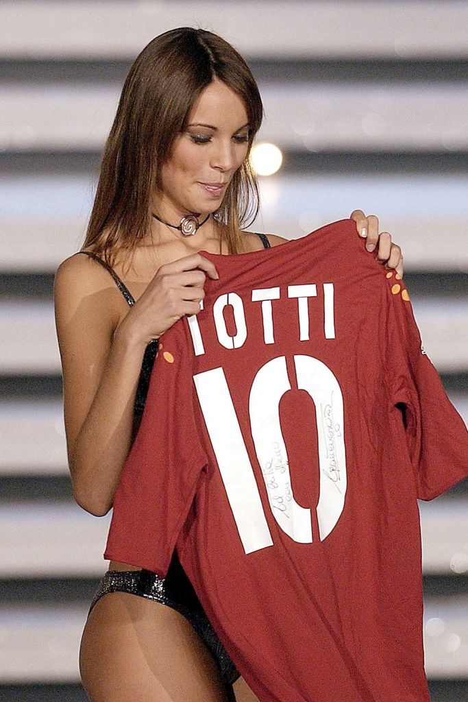 Miss Italy 2003 contestant and Roma fan, Erika Marinelli, poses with a Francesco Totti shirt 