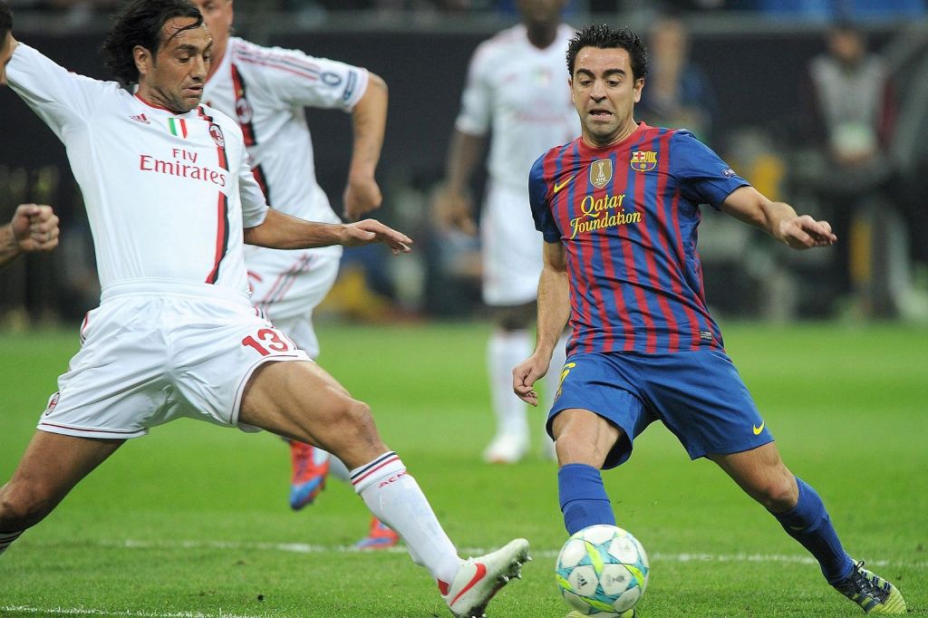  Alessandro Nesta tries to stop Xavi as two footballing greats met at the Nou Camp but it was Barcelona who prevailed