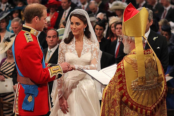 Prince William and Kate Middleton exchange rings in front of the Archbishop of Canterbury at Westminster Abbey, London.