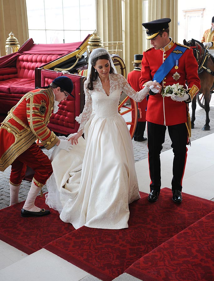 Prince William helps his wife The Duchess of Cambridge from the carriage.