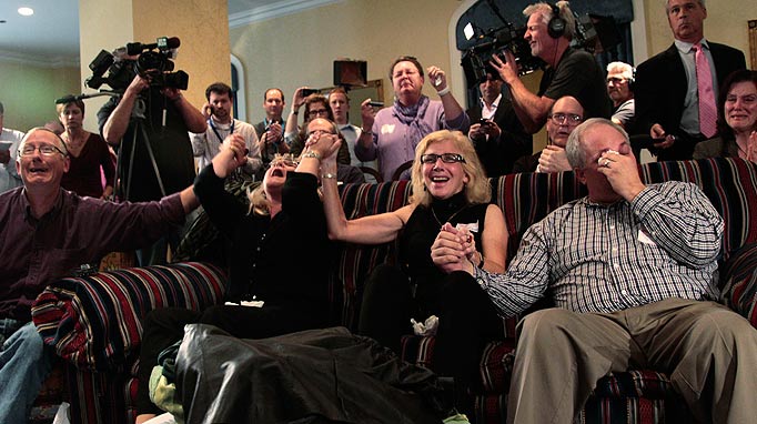 Supporters of Amanda Knox react as they watch a television news broadcast about her appeal verdict from a hotel suite in downtown Seattle Monday