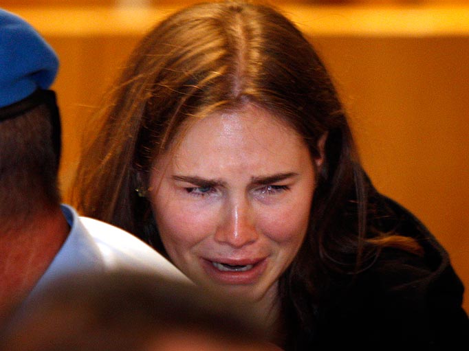 Amanda Knox breaks in tears after hearing the verdict that overturns her conviction and acquits her of murdering her British roommate Meredith Kercher, at the Perugia court, central Italy, Monday, Oct. 3, 2011