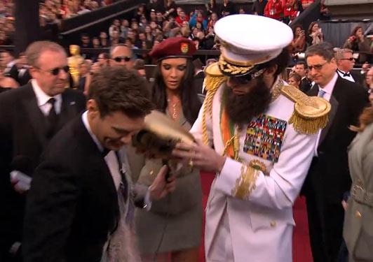 Sacha Baron Cohen tipped the "ashes of King Jong II" over US reporter Ryan Seacrest