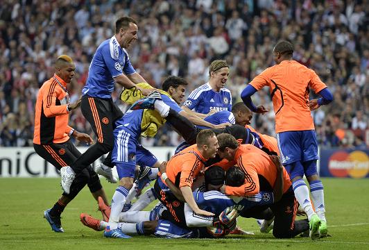 PILE ON ... Chelsea players celebrate with Didier Drogba