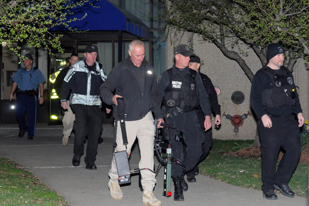 Police and federal officials exit an apartment complex at 364 Ocean Avenue with a possible connection to the earlier expolsions during the Boston Marathon on April 15, 2013 in Revere, Massachusetts.