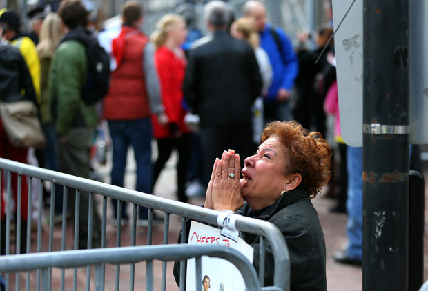 A woman kneels and prays