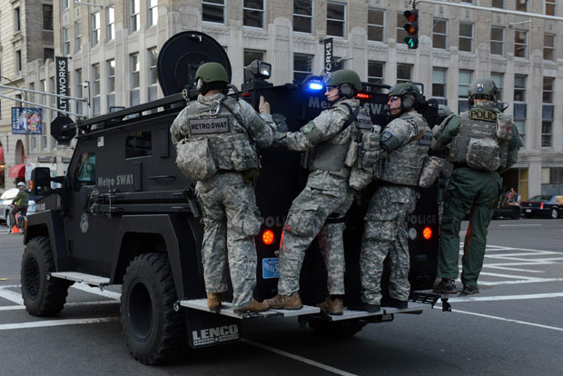 A swat team arrives at the corner of Stuart Street