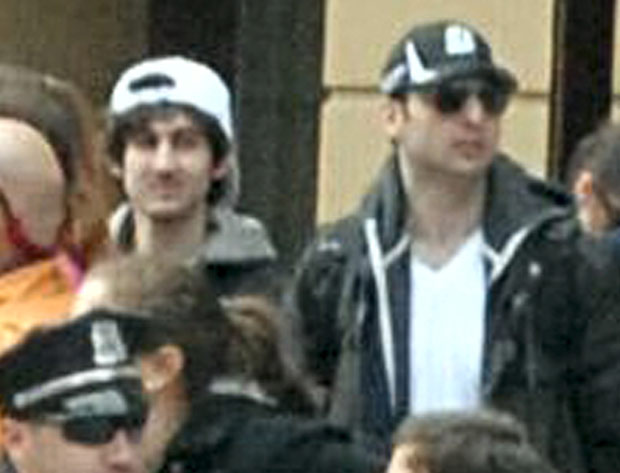 Police are hunting the 'white cap' suspect on the left. The 'black cap' is believed to have died