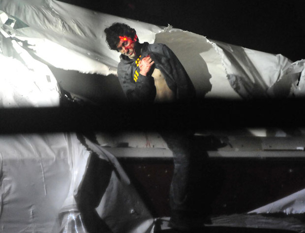 Boston bombings suspect Dzhokhar Tsarnaev on April 19 as he emerged from a boat stored in a Watertown, Mass., backyard. The red dot of a police sharpshooter's laser sight can be seen on him