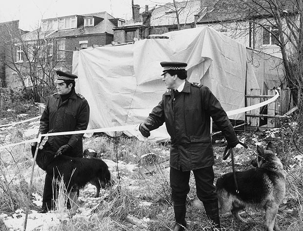 Police search the rear of Nilsen's garden flat in Melrose Avenue