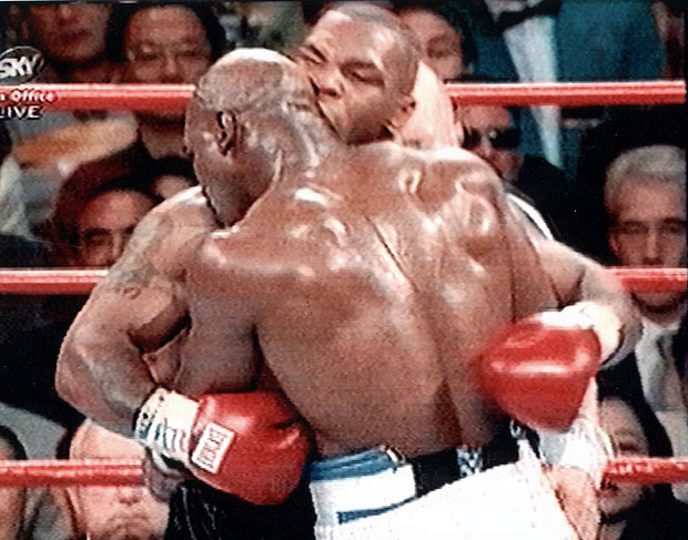 : Mike Tyson takes a bite of Evander Holyfield's ear during their 1997 fight