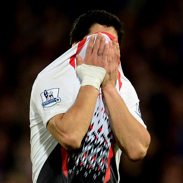 A dejected Luis Suarez of Liverpool reacts following his team's 3-3 draw with Crystal Palace