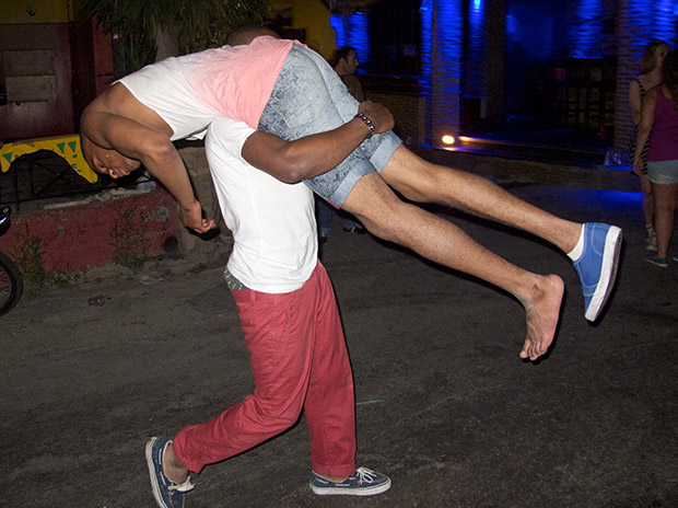 A man carries his friend along the Kavos strip