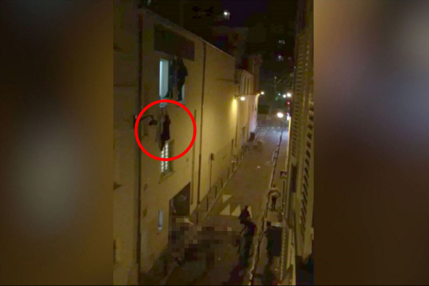 People hanging from windows to escape terrorists