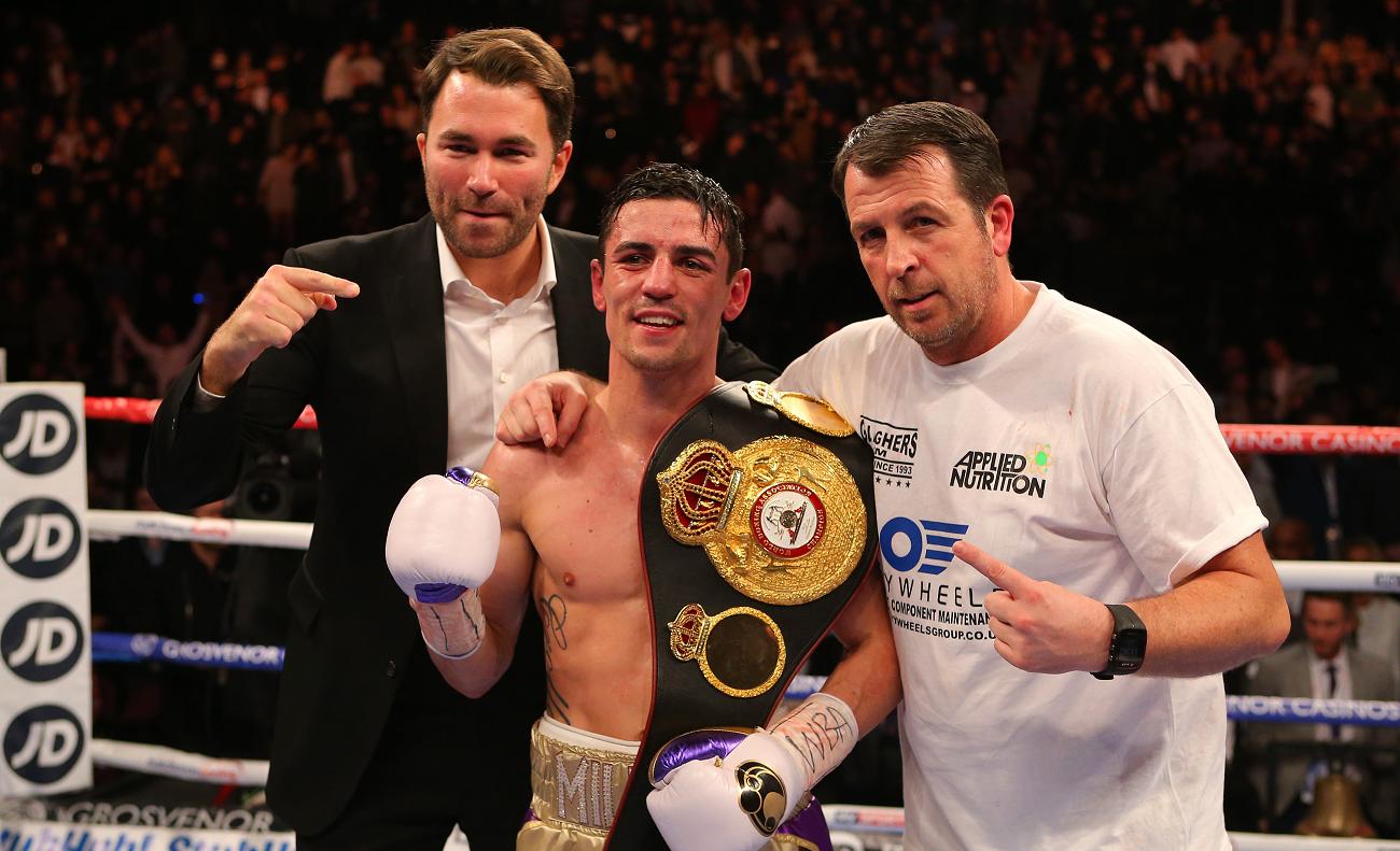 Promoter Eddie Hearn and trainer Joe Gallagher pose with the new champion