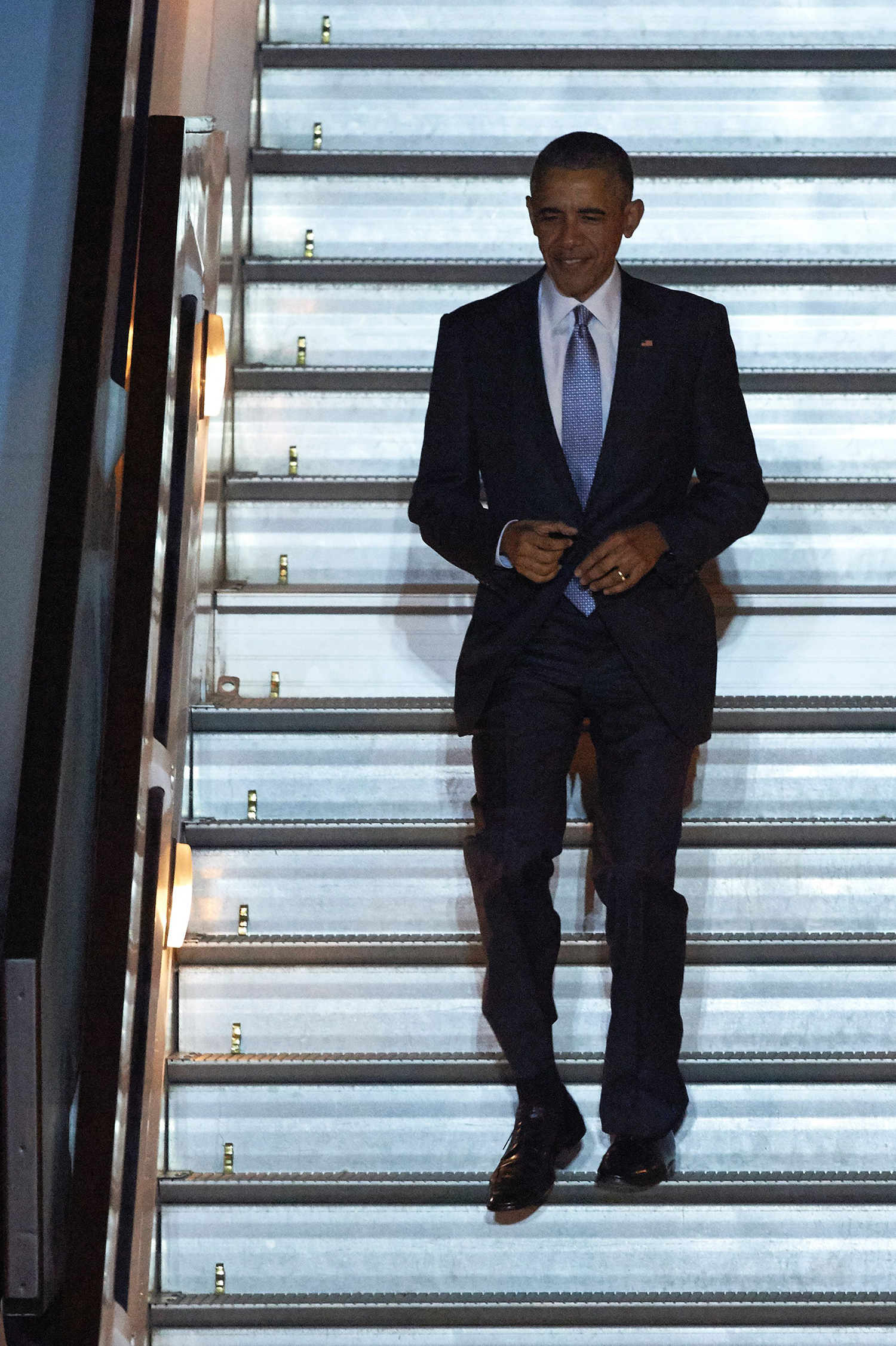 US President Barack Obama walks down to the tarmac from Air Force One after landing at Stansted Airport in London on April 21, 2016 for a UK visit.