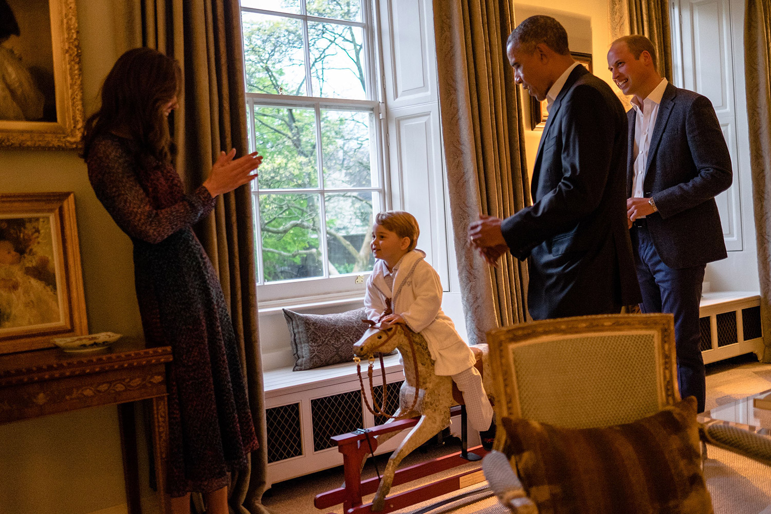 Handout photo issued by Kensington Palace of US President Barack Obama (2nd right) and the Duke of Cambridge (right) while the Duchess of Cambridge plays with Prince George. PRESS ASSOCIATION Photo. Picture date: Friday April 22, 2016. See PA story ROYAL Obama.