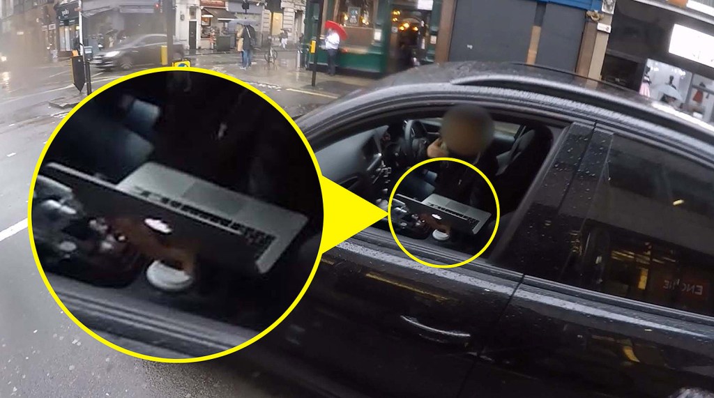  The woman was caught on the cyclists helmet cam using her laptop in traffic