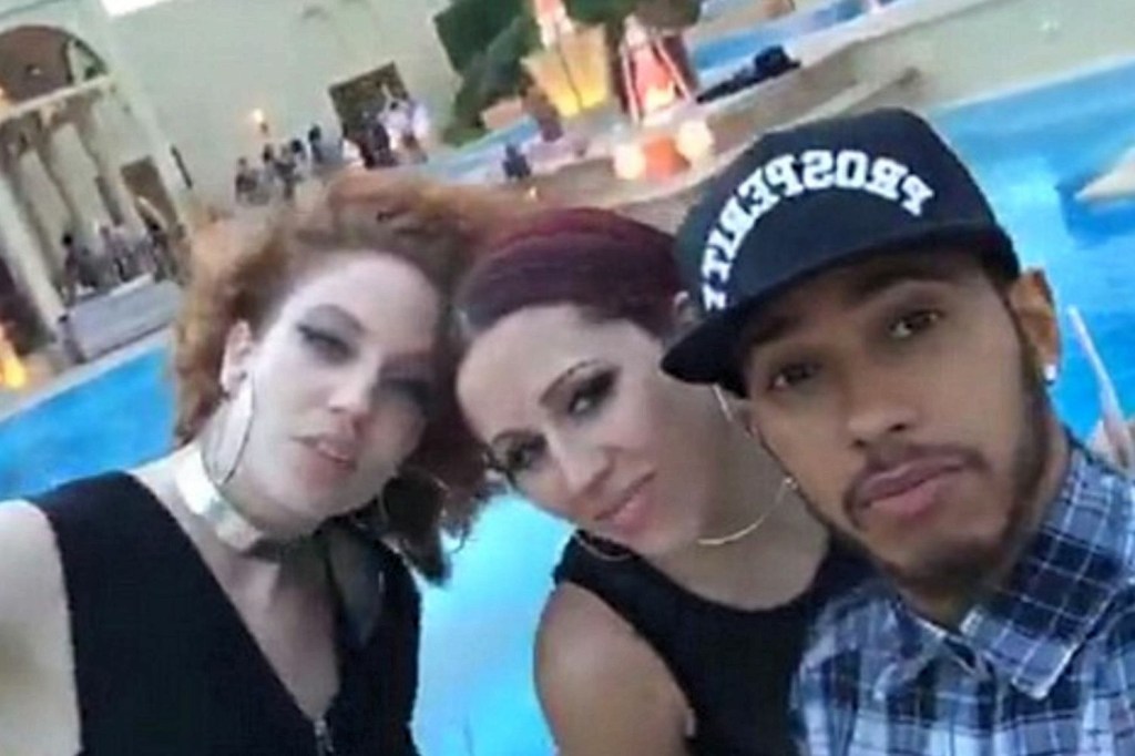  Hamilton is seen encouraging two girls to jump into a swimming pool