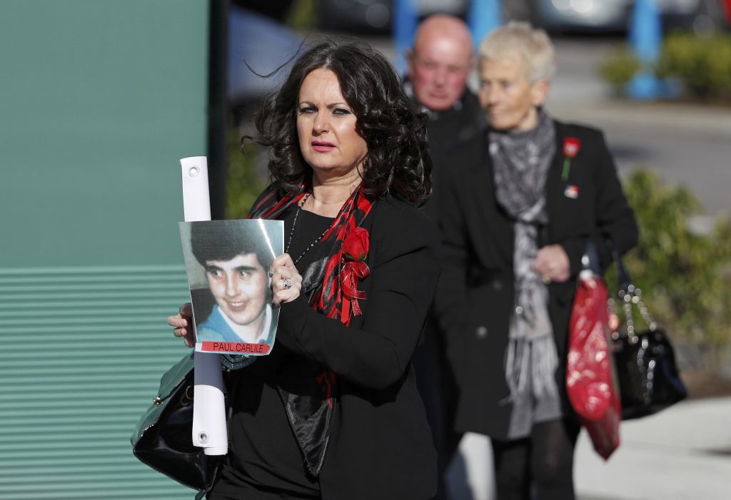  Donna Miller holds a photograph of her brother Paul Carlile, as she arrives to hear the jury deliver its verdict at the new inquests into the Hillsborough disaster, in Warrington