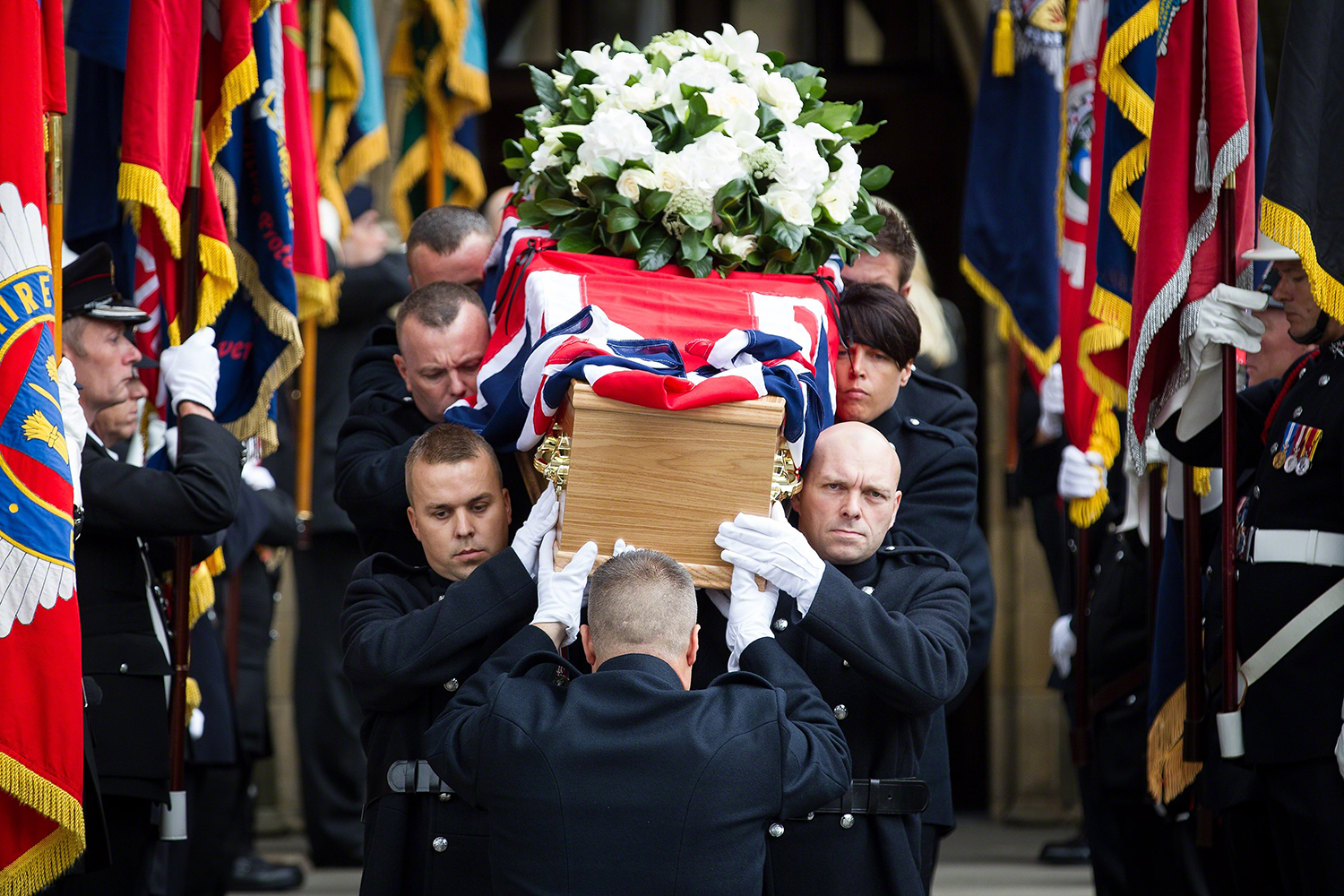 Stephen Hunt's coffin is carried from the church after the service . The funeral of fireman Stephen Hunt at Bury Parish Church today (Tuesday 3rd September 2013) . Stephen Hunt died whilst tackling a blaze at Paul's Hair World in Manchester City Centre in July 2013