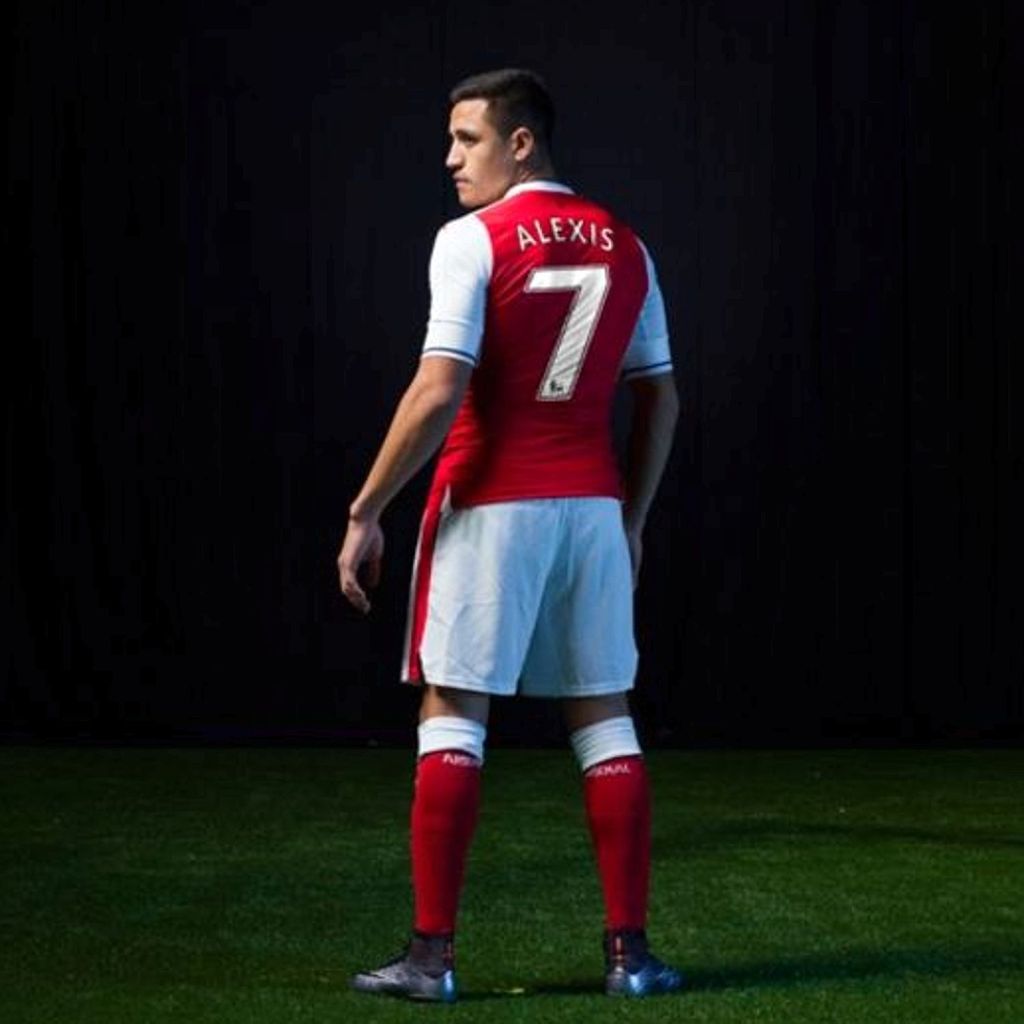  Alexis Sanchez models the new Arsenal kit, sporting No7, suggested he is set to stay on at the Gunners