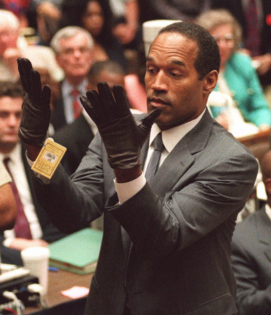 'If the glove don't fit, you must acquit': Simpson tries on gloves linked to the murder