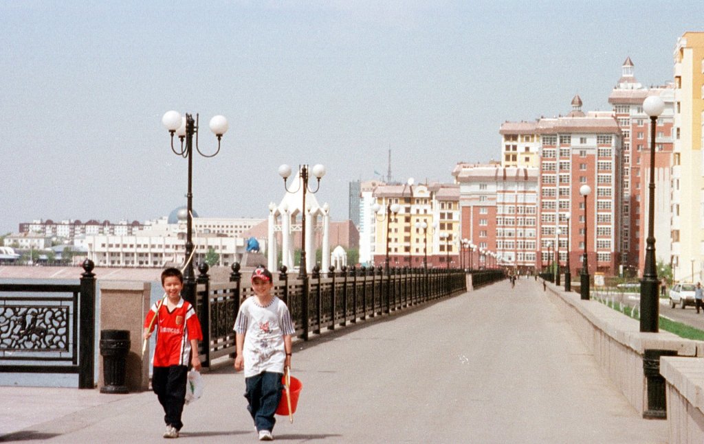 Children walk along a promenade with finishing gear in Astana, Kazakhstan