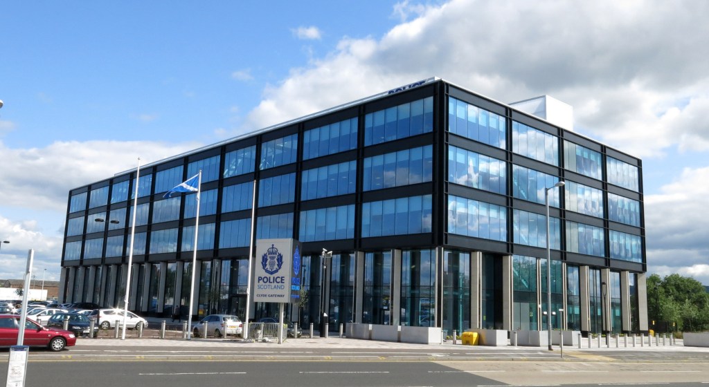  Police Scotland (headquarters pictured) are now investigating the incident where a man jumped from a moving taxi before being hit by a bus