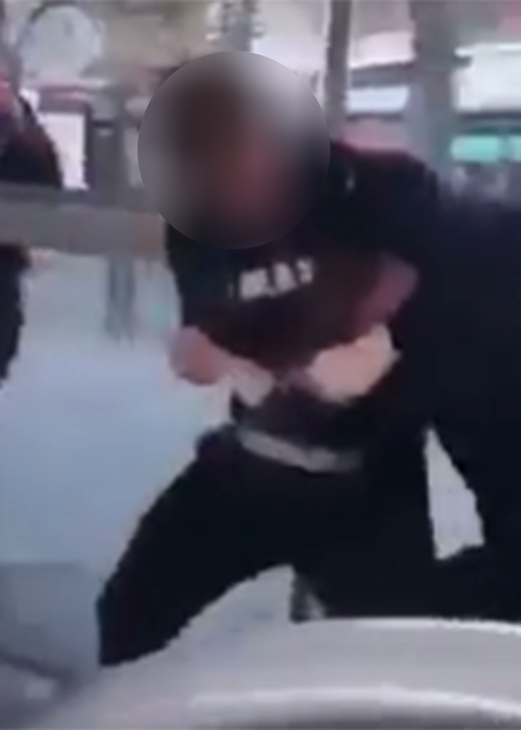  The two young men scrap in the bus stop as punches and obscenities fly during the bust up