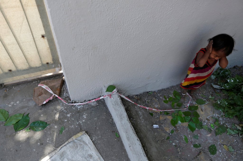  Shivani, 15 months, has to be tied to a rock by a length of ticker tape when her mother goes out to work