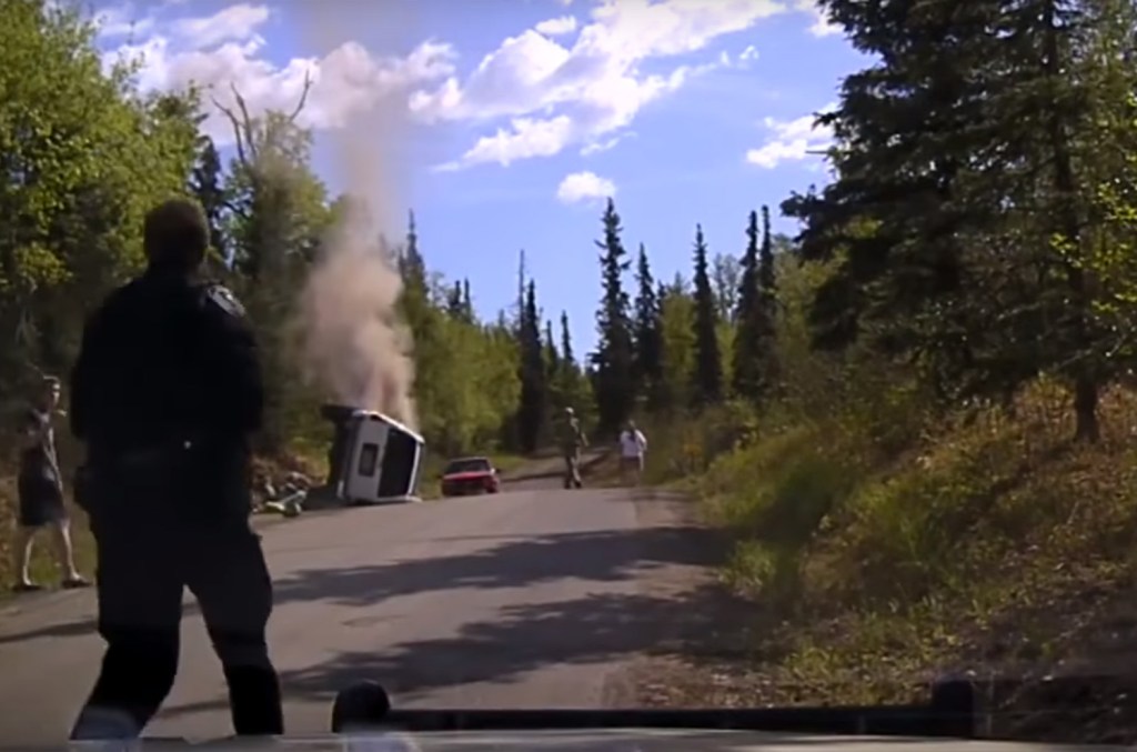  Police officer Mitchel Veenstra runs towards the smoking car