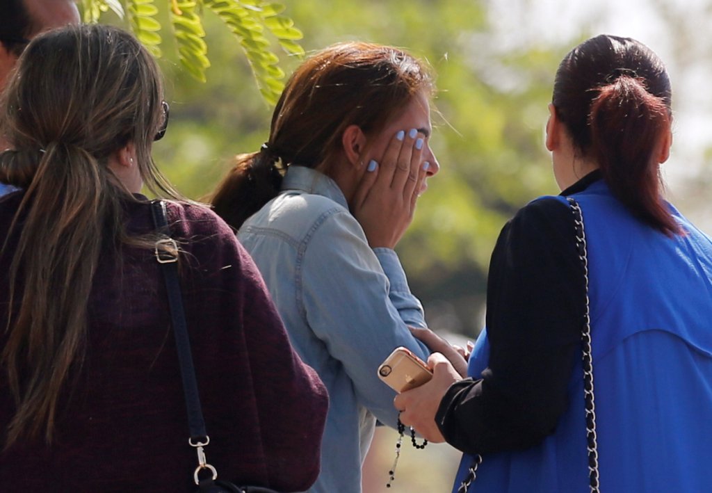 Unidentified relatives and friends of passengers who were flying in an EgyptAir plane wait outside the Egyptair in-flight service building in Cairo