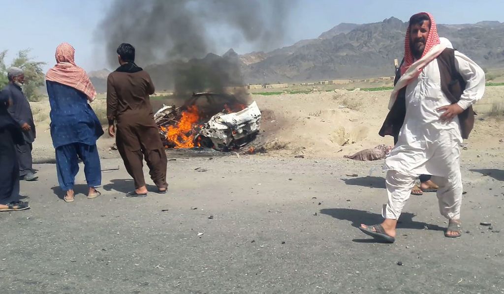 Pictured: The burning wreckage of the car carrying Mullah Akhtar Mansour and his driver after US drone strike