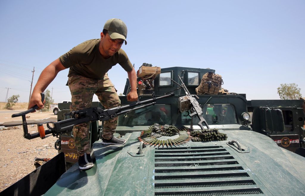  The Iraqi army check their equipment ahead of the raid on Fallujah