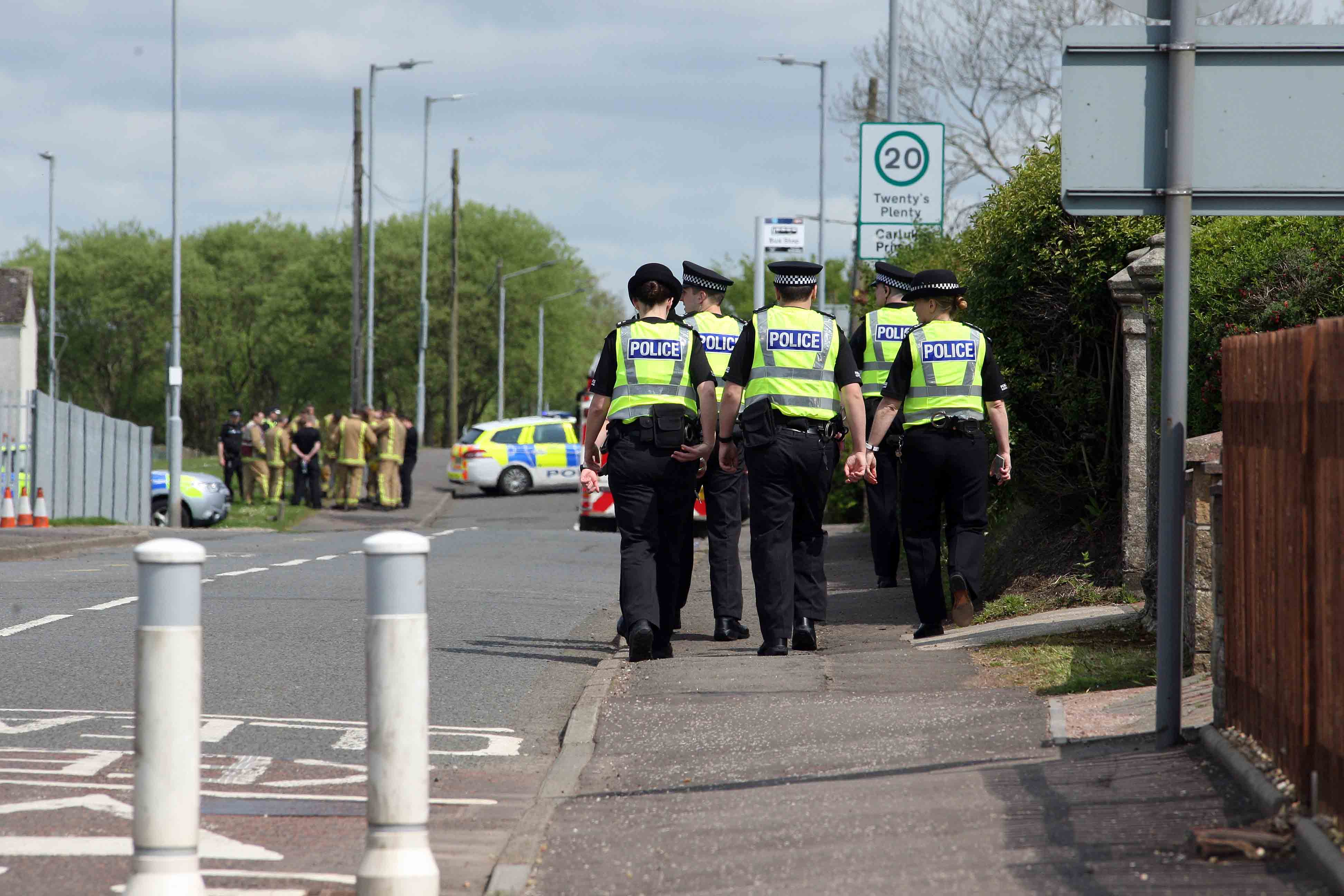  Police outside Carluke Primary as schools across the country received bomb threats for the second day running. Anti-terror cops are now probing whether the threats came from automated 'robo-calls'