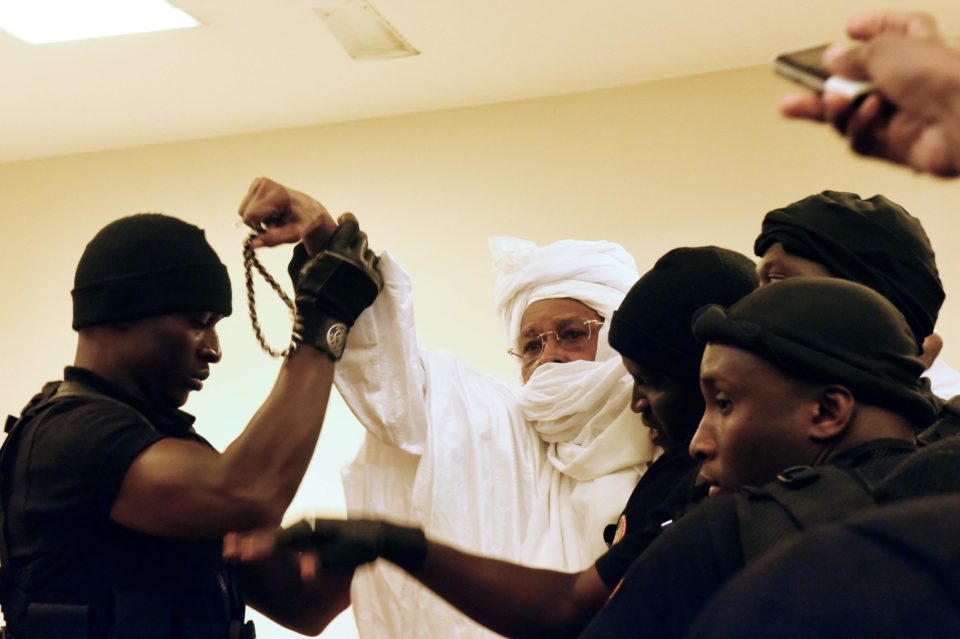  The former dictator raised his fists and shouted anti-French colonial slogans as he was led out by burly guards