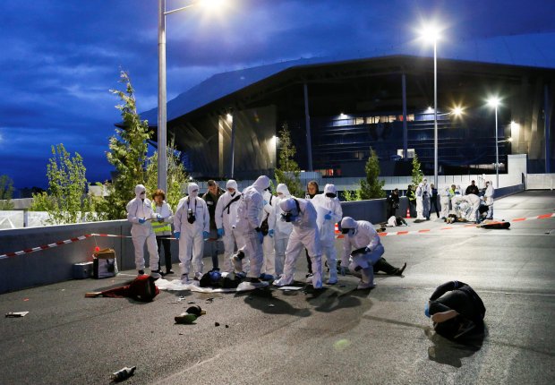 French forensic experts take part in a mock attack drill outside the Grand Stade stadium in Decines