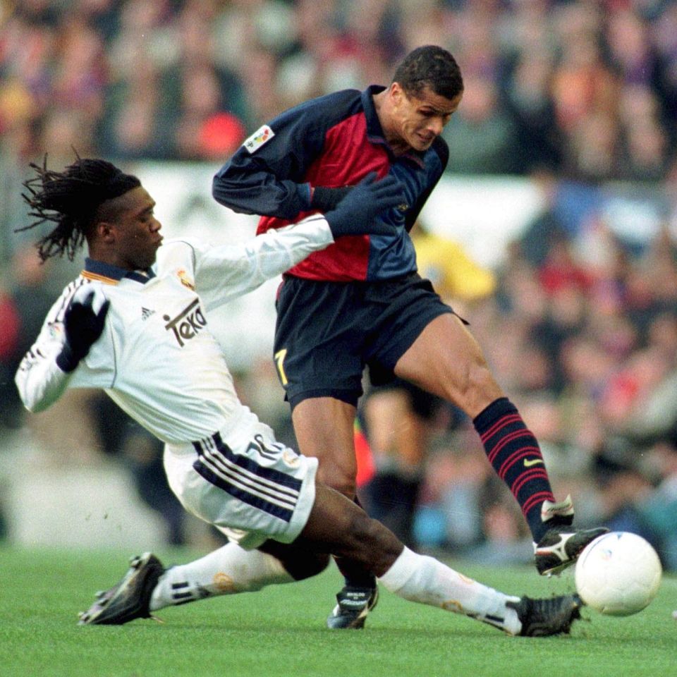 Clarence Seedorf puts a tackle in on Rivaldo during a Clasico clash between Real Madrid and Barcelona