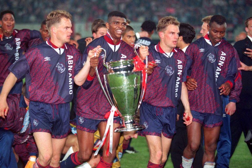 Nwankwo Kanu, along with the De Boer twins and Finidi George, holds the Champions League trophy