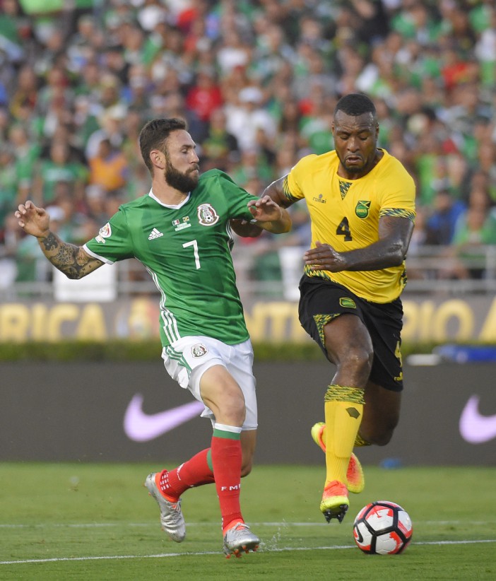 Mexico defender Miguel Layun, left, and Jamaica defender Wes Morgan battle for the ball during a Copa America group C soccer match at the Rose Bowl, Thursday, June 9, 2016, in Pasadena, Calif. (AP Photo/Mark J. Terrill)