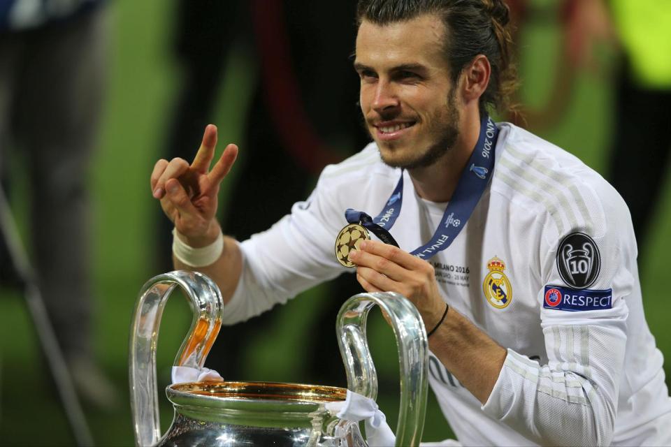 Bale poses with the Champions League trophy