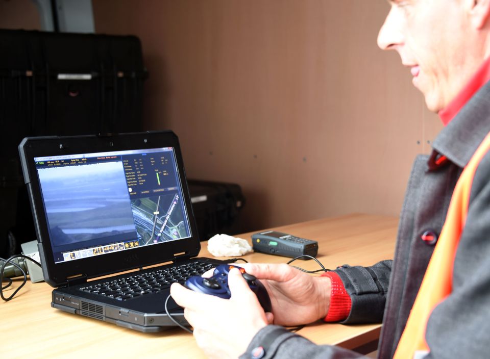  An operator controls a surveillance drone (or UAV for unmanned aerial vehicle) flying over the Channel Tunnel