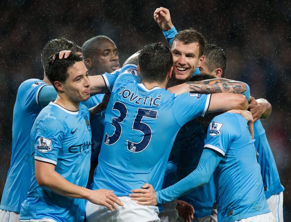  Edin Dzeko celebrates scoring a goal with his Manchester City team-mates